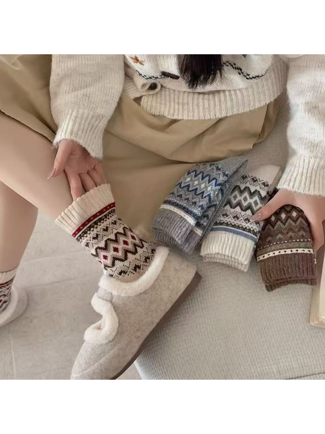 Geometric crew socks styled with a slipper beside folded color options