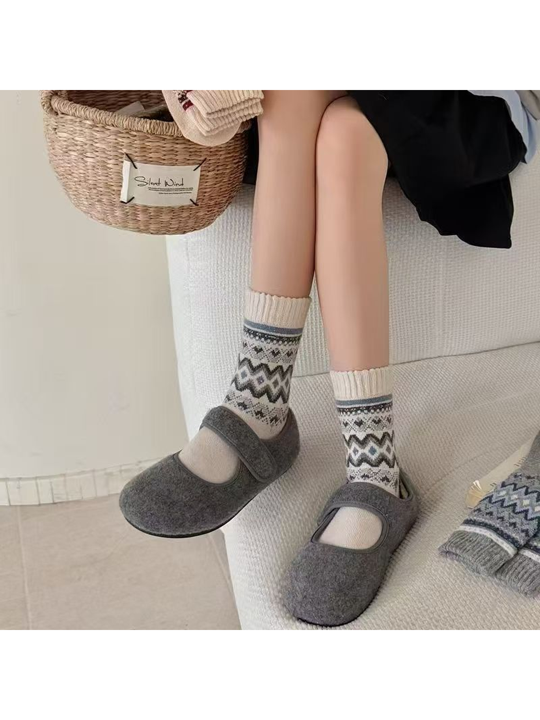 Ivory geometric crew socks worn with gray strap shoes