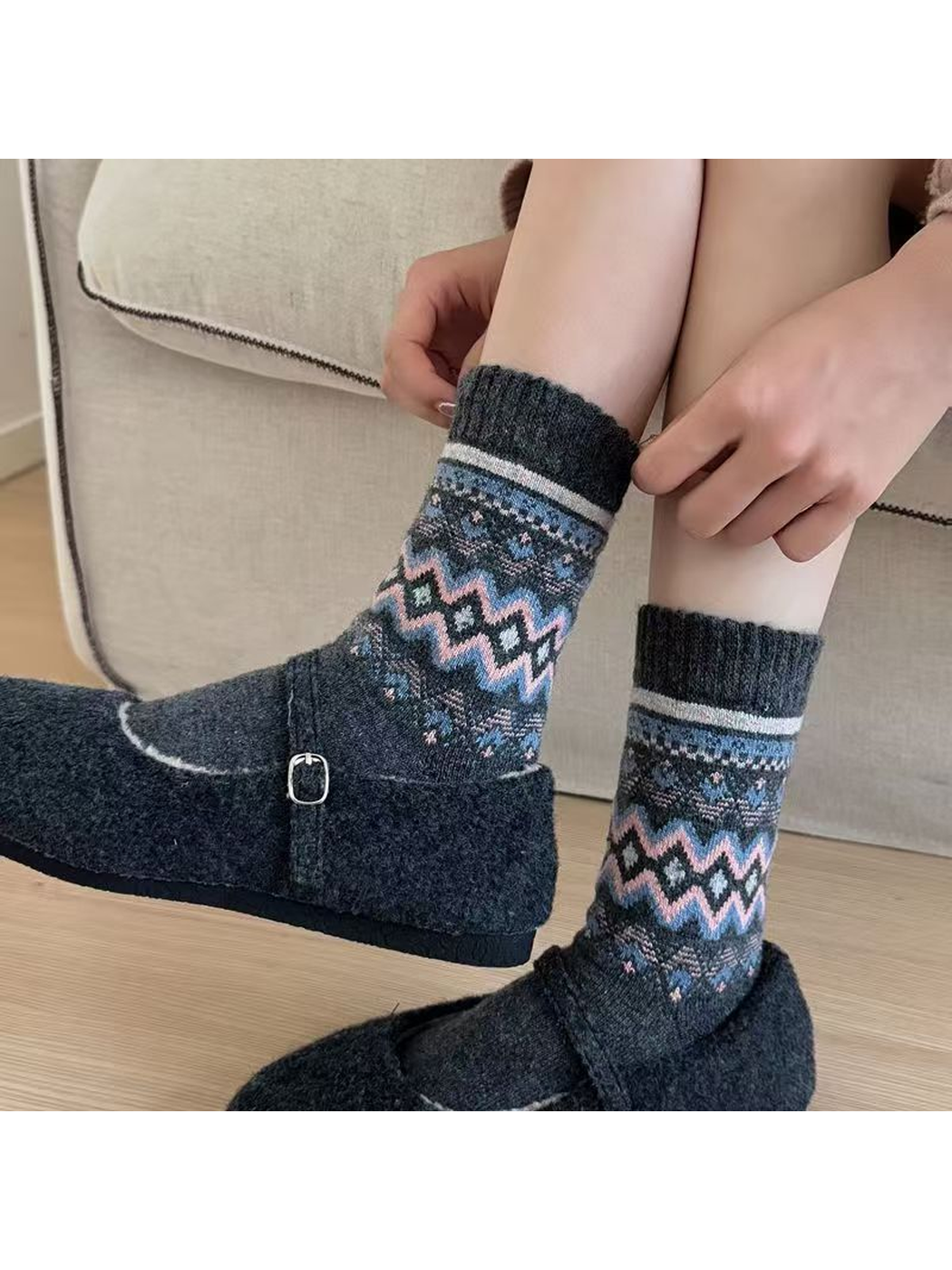 Dark gray geometric crew socks worn with charcoal strap shoes