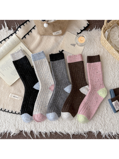 Five color-blocked speckled crew sock styles displayed together