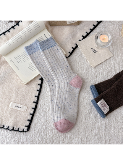 Cream speckled crew socks with light blue cuff and pink accents