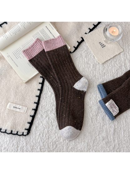 Brown speckled crew socks with pink cuff and pale gray accents