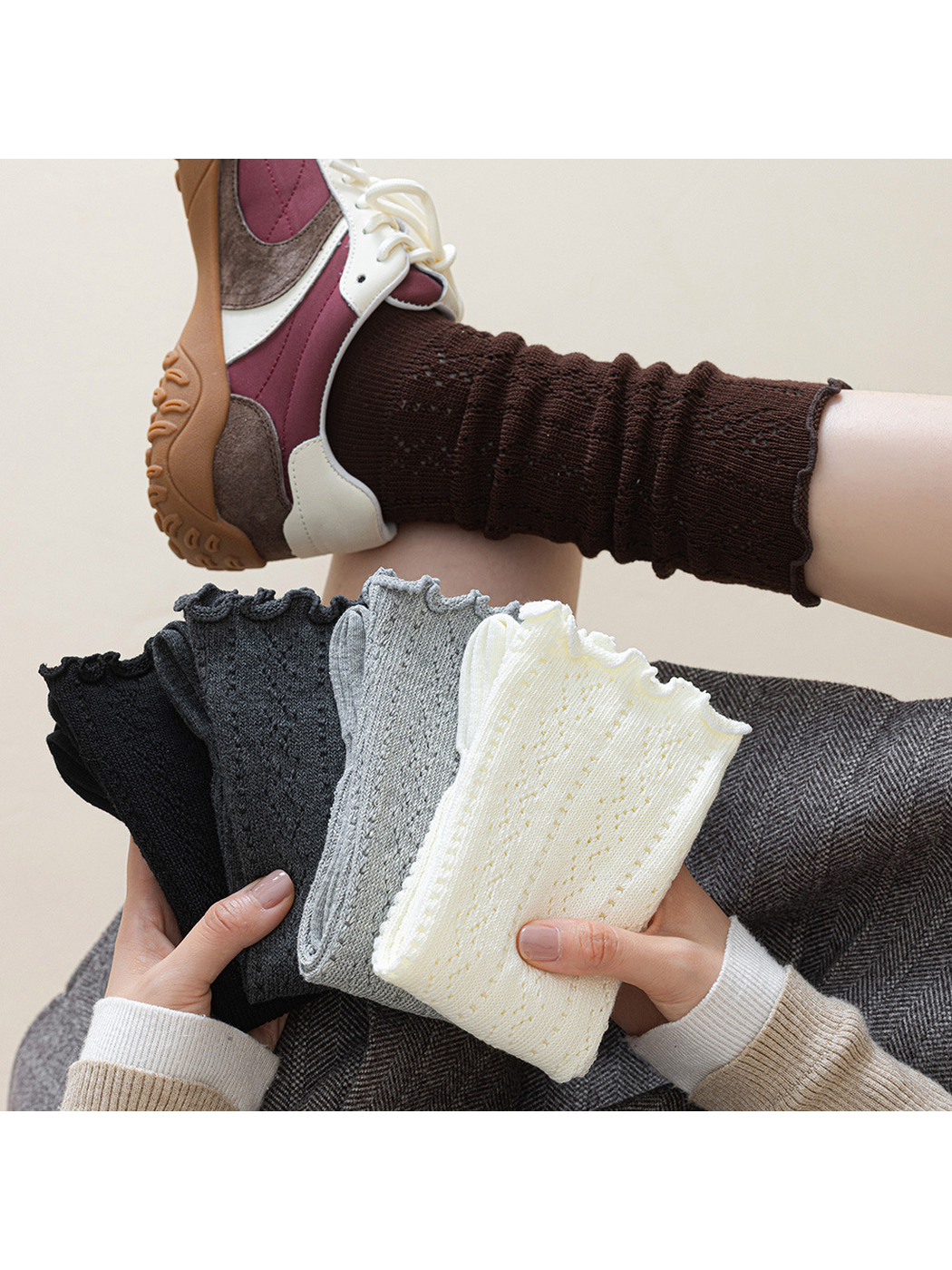 Black, dark gray, light gray, ivory and brown pointelle socks displayed together