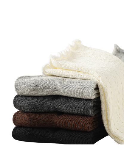 Ivory, light gray, dark gray, brown and black pointelle socks stacked together