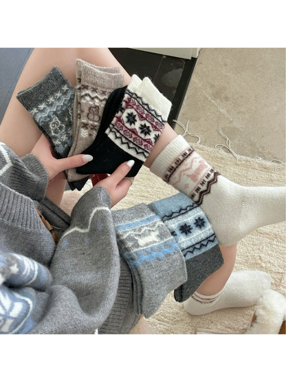 Assorted patterned crew socks styled together in a cozy indoor setting