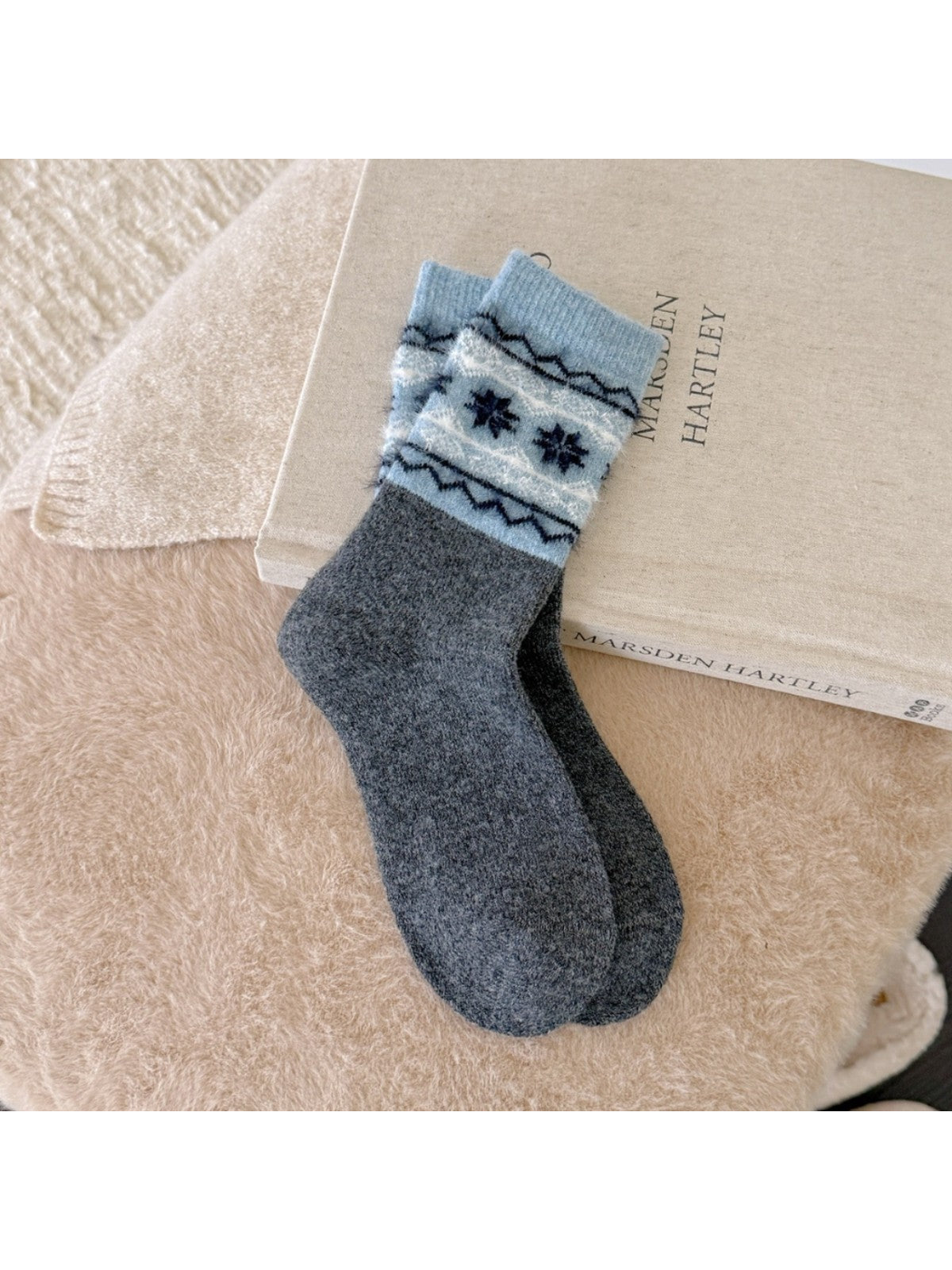 Dark gray crew socks with blue cuffs and navy snowflakes