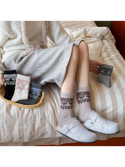 Light taupe bow-pattern crew socks worn with gray slippers beside three color variants
