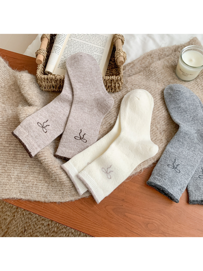 Beige, ivory and light gray socks arranged to show the reverse sides