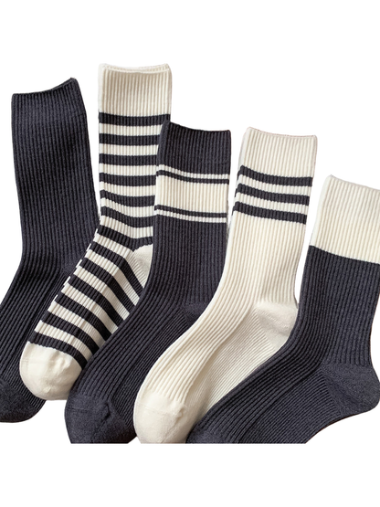 Five dark gray and ivory ribbed crew sock styles displayed together