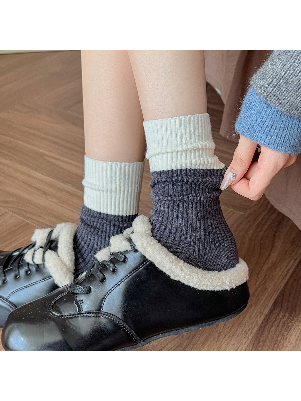 Dark gray and ivory color-block crew socks worn loosely scrunched above black shoes