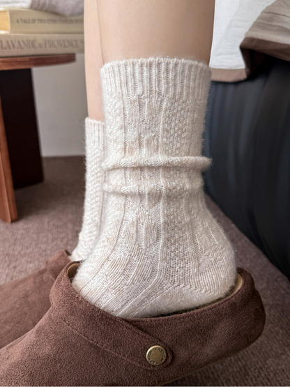 Close-up of a beige sock with its patterned cuff folded down