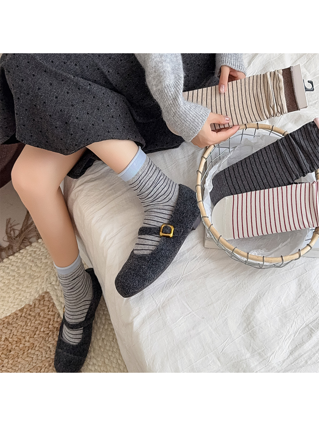 Light gray striped socks worn with dark flats beside additional color options
