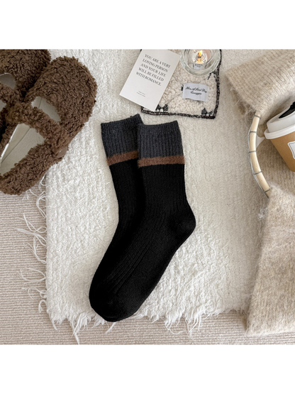 Black ribbed crew socks with a brown fuzzy stripe