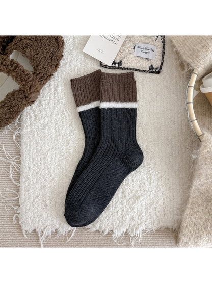 Gray ribbed crew socks with a brown cuff and white fuzzy stripe