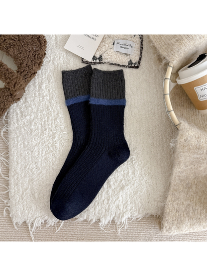 Navy ribbed crew socks with a gray cuff and blue fuzzy stripe