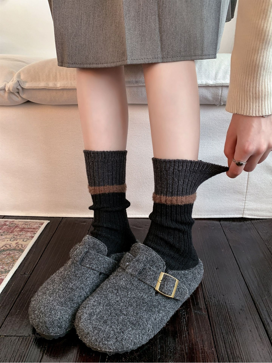 Close-up demonstrating the stretch of the black ribbed sock cuff