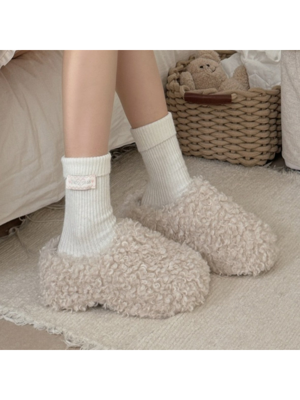 Ivory ribbed crew socks worn with plush slippers
