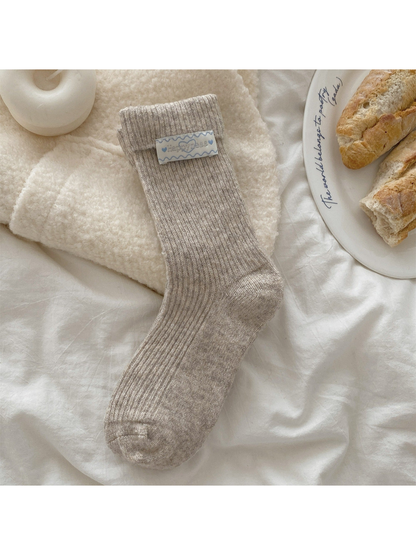 Greige ribbed crew sock with fold-over cuff and heart label