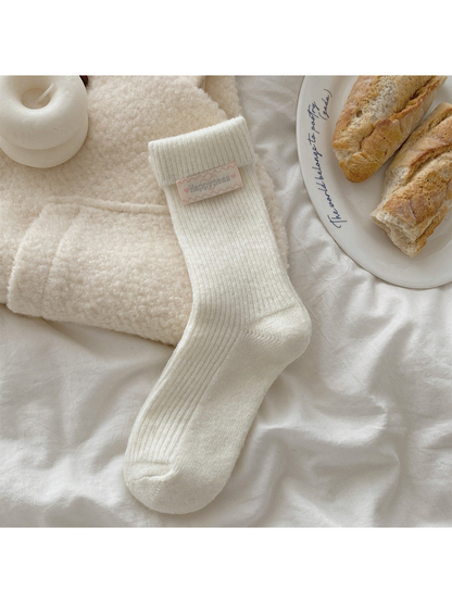 Ivory ribbed crew sock with fold-over cuff and heart label