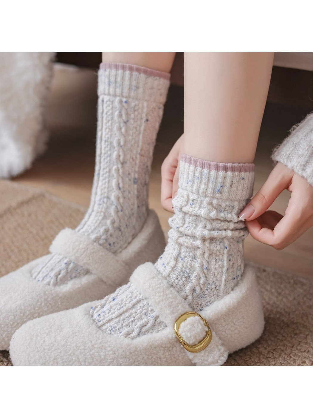 Ivory cable-textured socks worn straight and gathered at the ankle