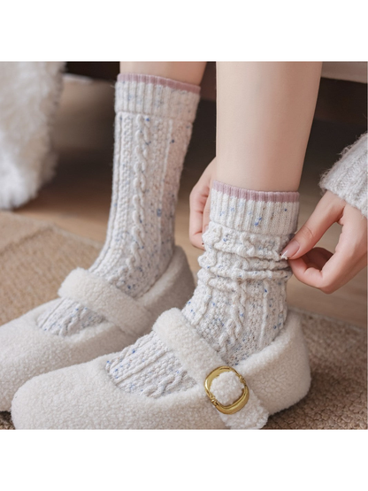 Ivory cable-textured socks worn straight and gathered at the ankle