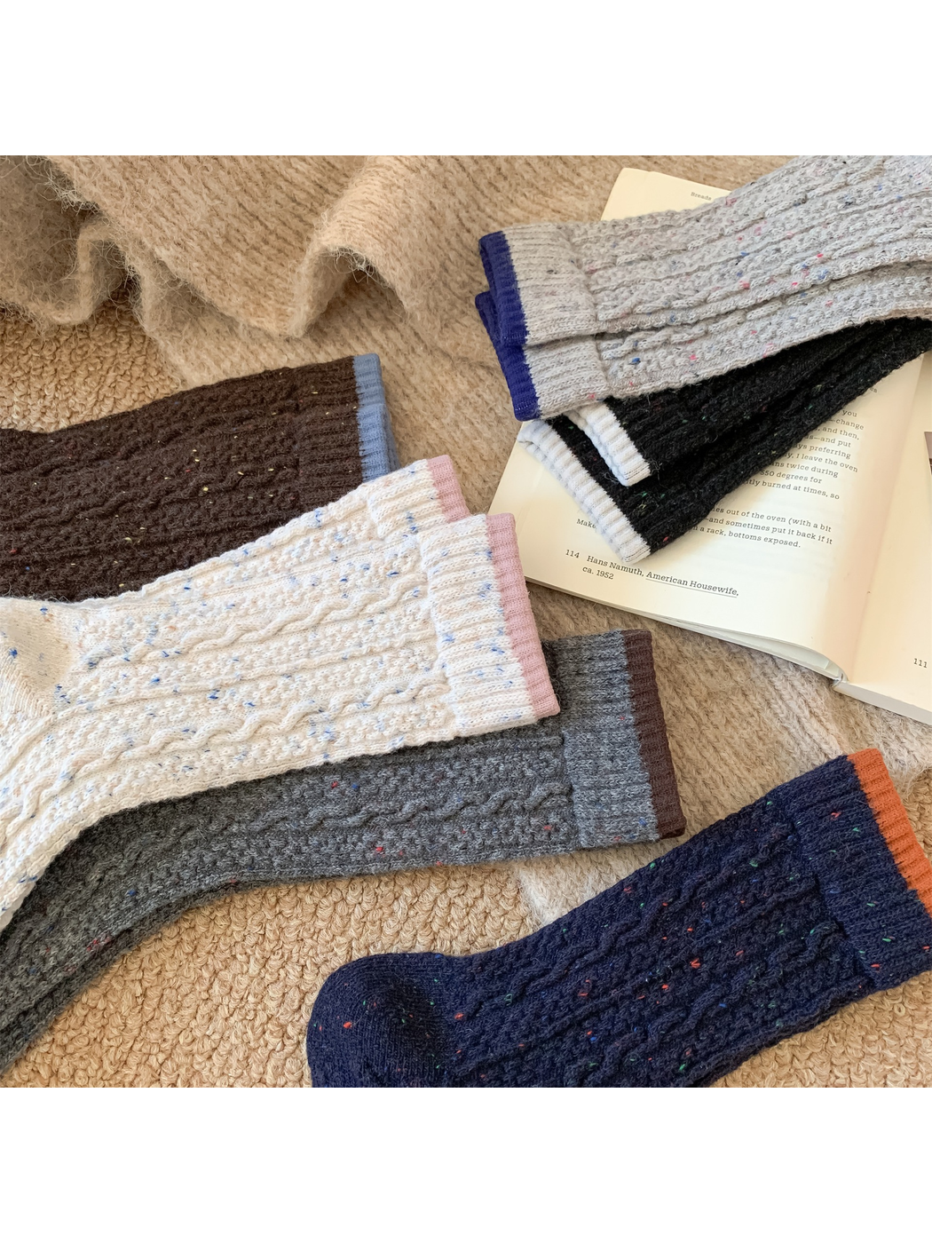 Close-up of cable textures, colored flecks and contrasting sock cuffs