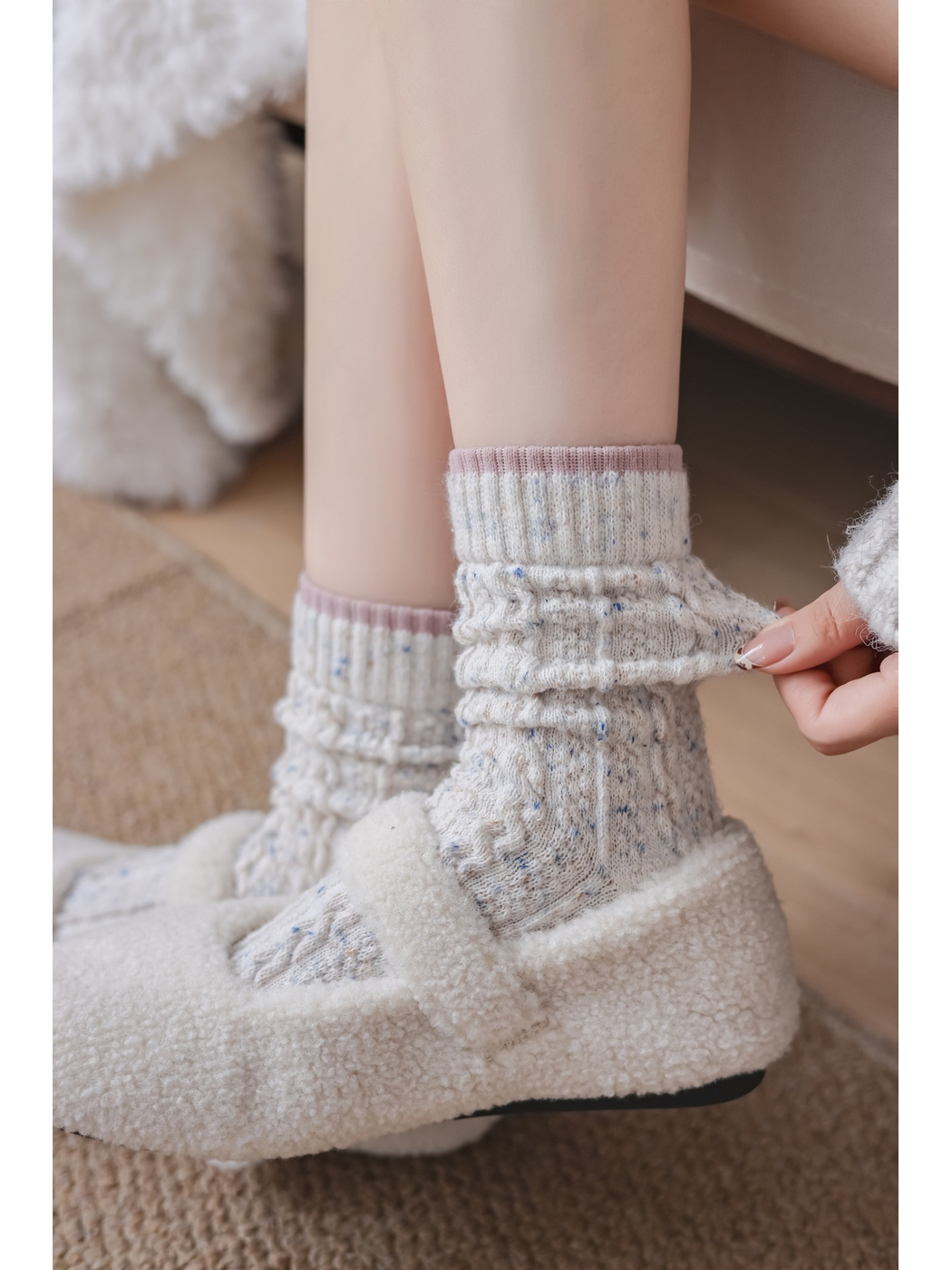 Close-up of the gathered ivory sock and contrasting pink cuff