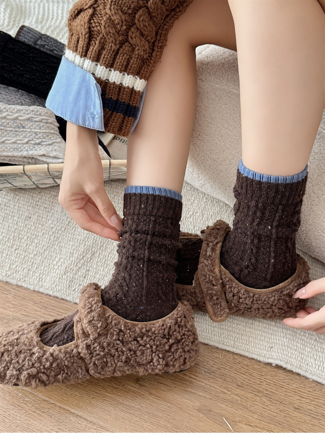 Dark brown cable-textured socks styled with brown fleece shoes