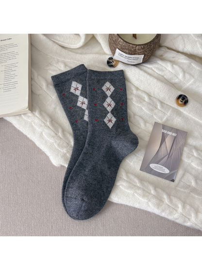 Dark gray crew socks with cream diamonds and small red bow motifs