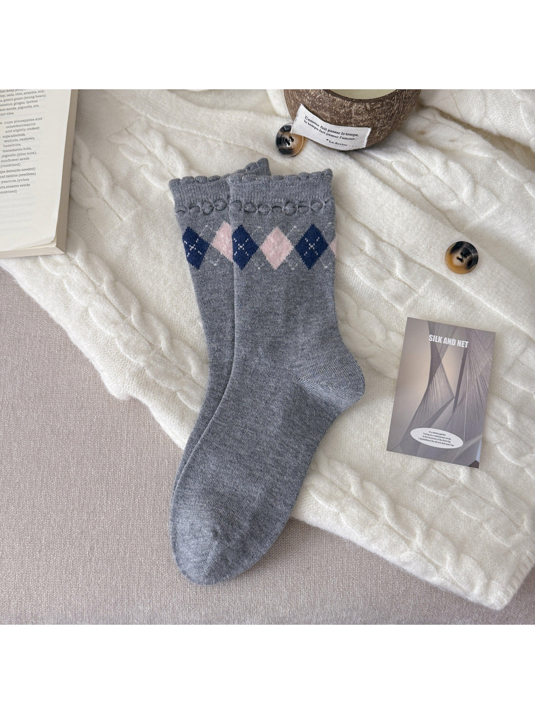 Light gray crew socks with pink and navy diamonds and scalloped cuffs