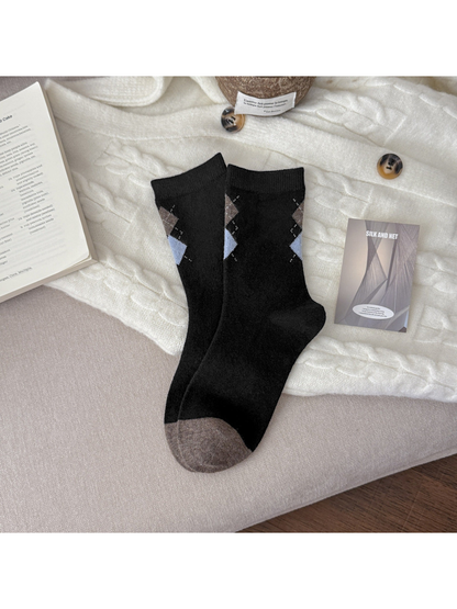 Black crew socks with brown and light blue diamonds and contrasting toes