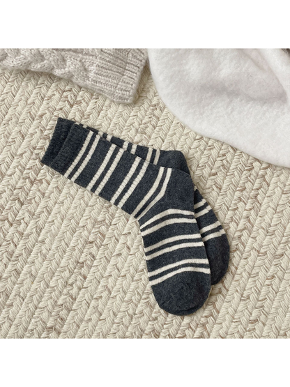 Dark gray crew socks with irregular ivory stripes, full pair view