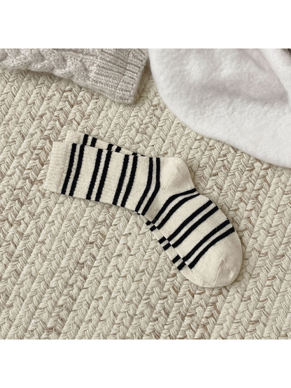 Ivory crew socks with irregular black stripes, full pair view