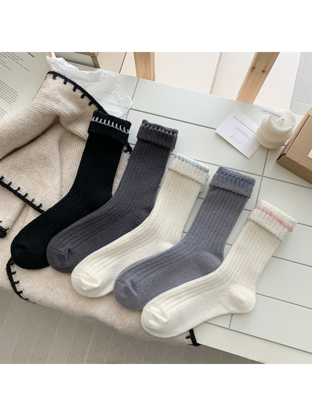 Five ribbed crew sock colorways arranged on a neutral tabletop