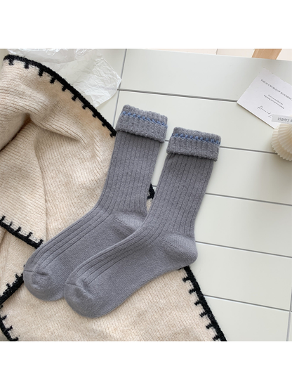 Medium gray ribbed crew socks with blue contrast stitching, pair laid flat