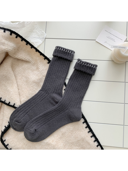 Dark gray ribbed crew socks with contrast stitching, pair laid flat