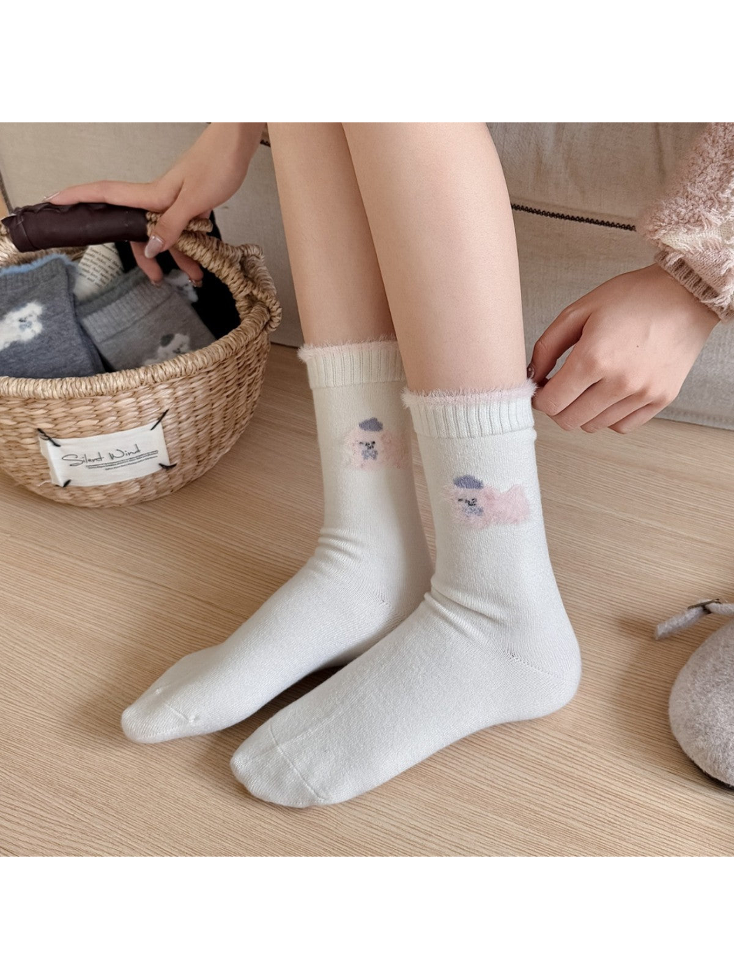 Ivory animal-motif crew socks worn without shoes