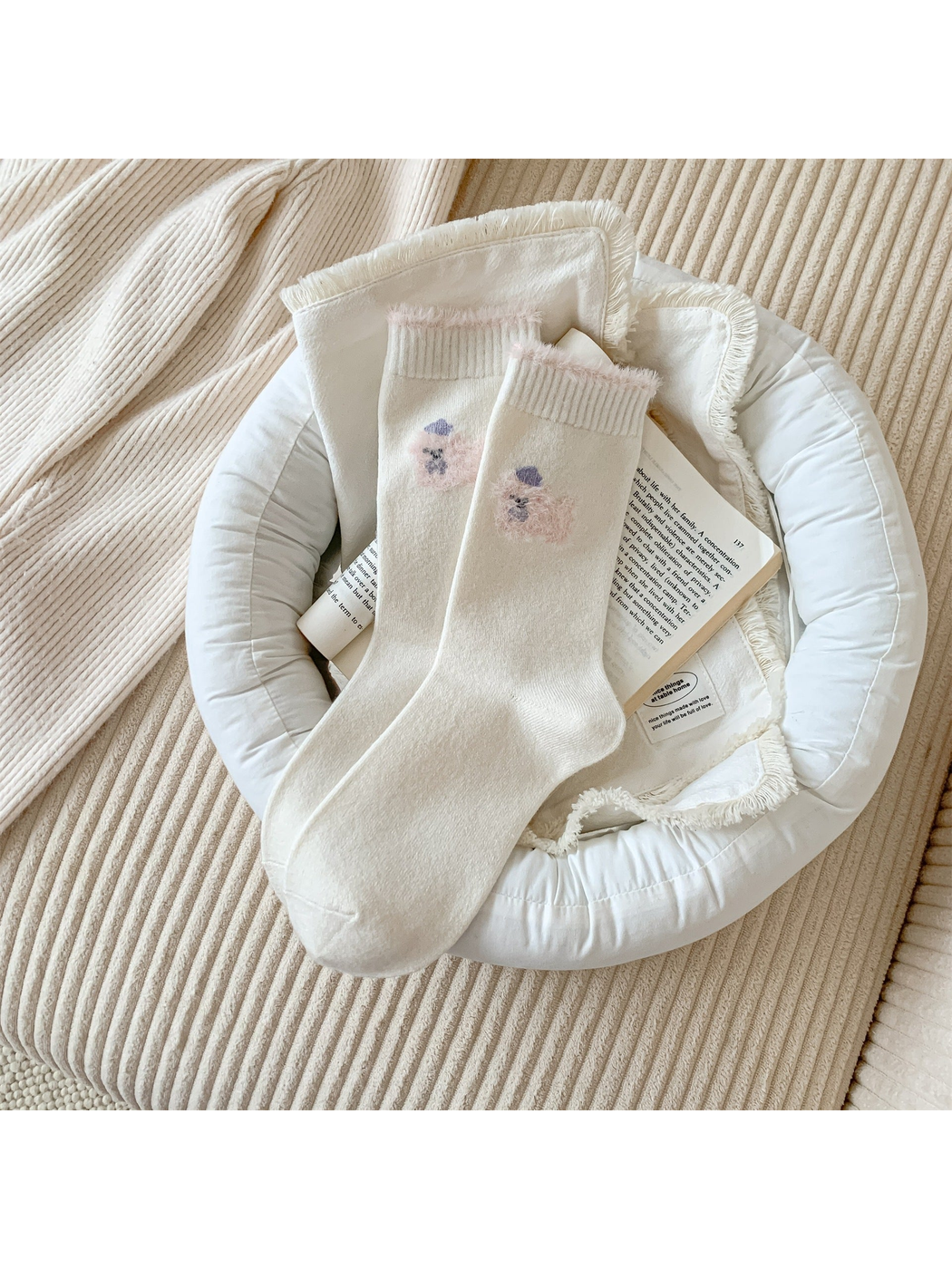 Ivory crew socks with a pink fuzzy animal motif and cuff trim