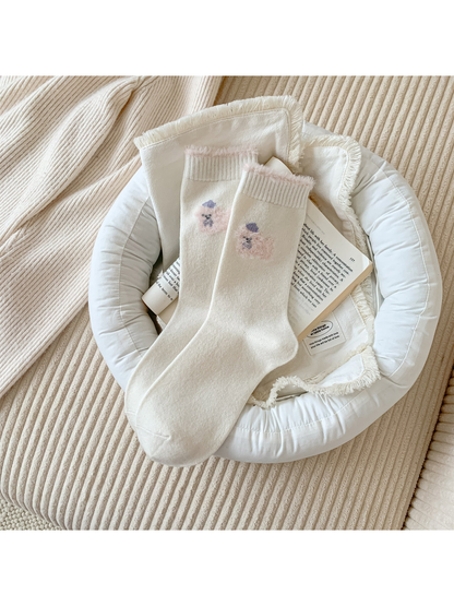 Ivory crew socks with a pink fuzzy animal motif and cuff trim