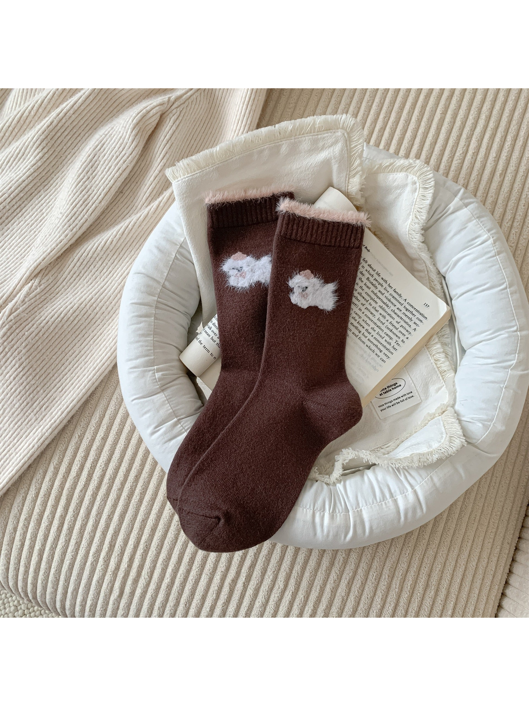Brown crew socks with a white fuzzy animal motif and pink cuff trim