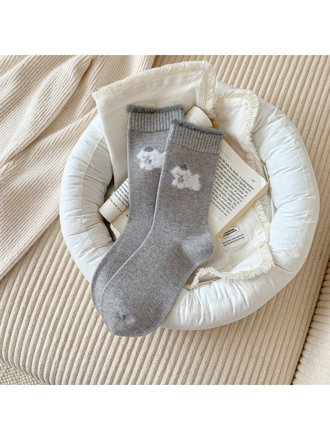 Light gray crew socks with a white fuzzy animal motif and gray cuff trim