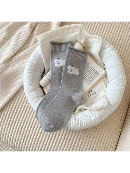 Light gray crew socks with a white fuzzy animal motif and gray cuff trim