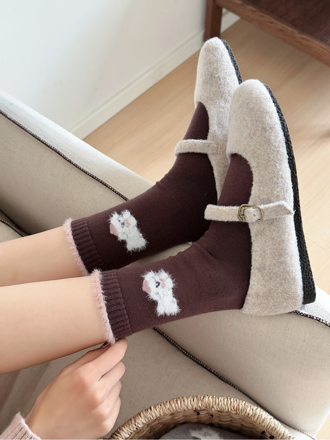 Brown animal-motif crew socks worn with cream buckle shoes