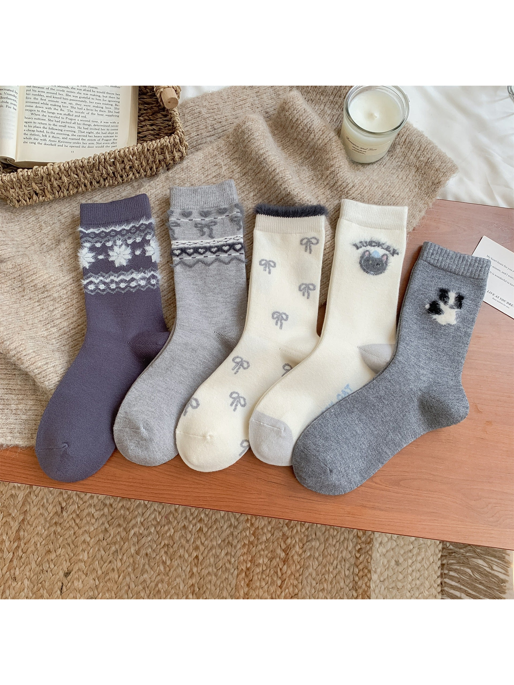 Five crew sock designs in ivory, gray and purple with fuzzy motifs