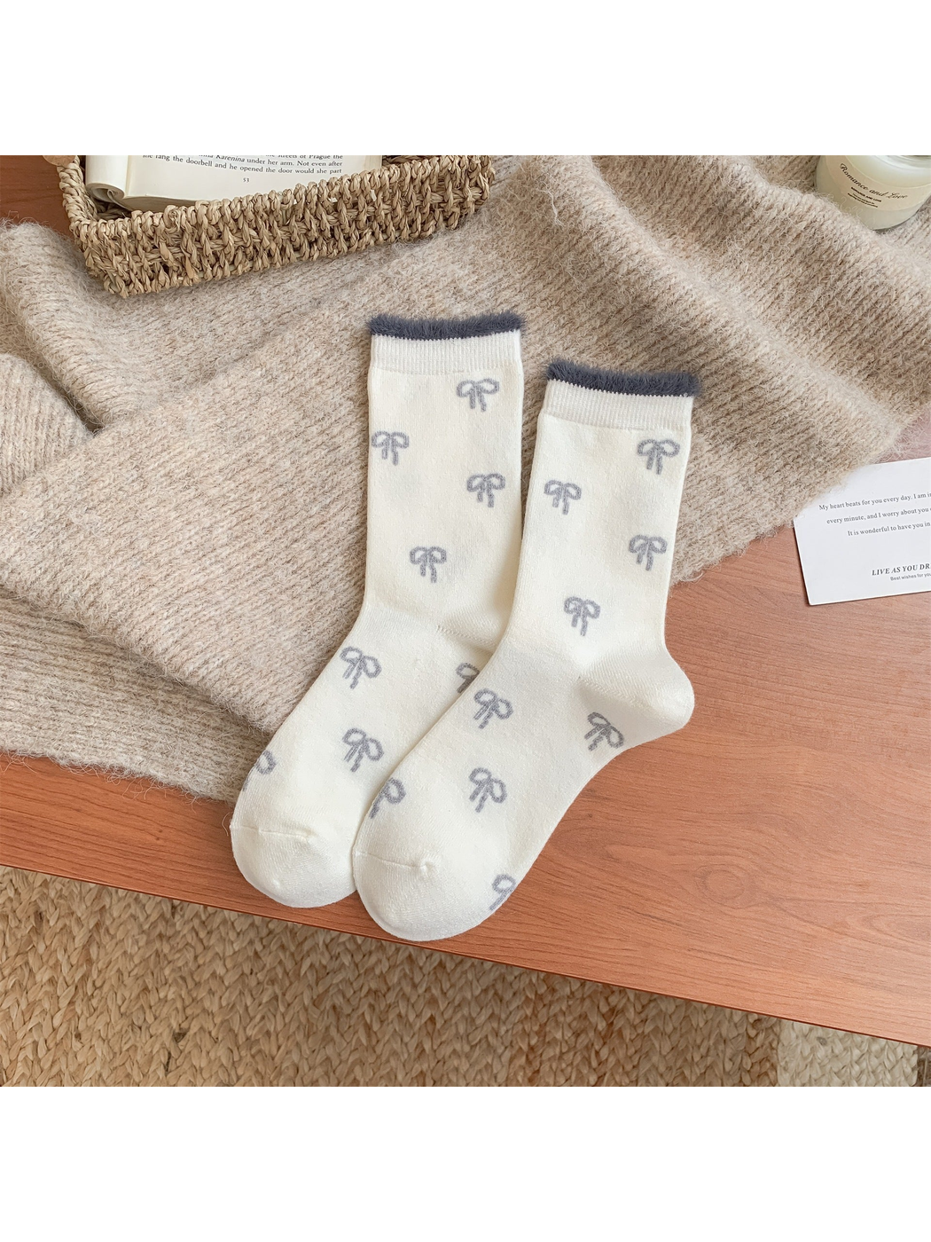 Ivory crew socks with gray bow pattern and fuzzy cuff trim