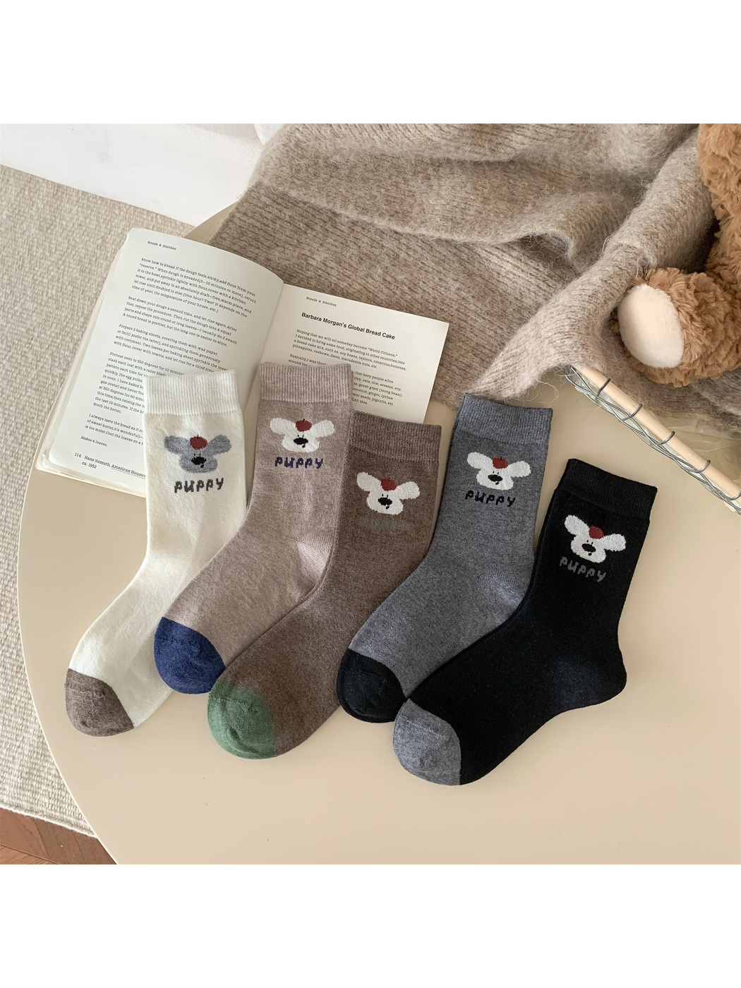 Five colors of puppy motif crew socks displayed together