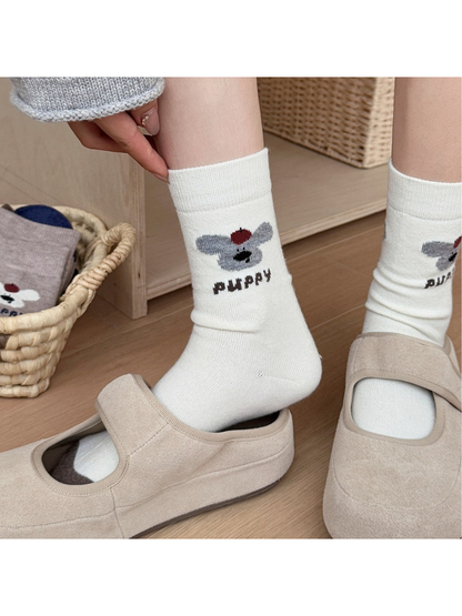 Ivory puppy motif crew socks worn with beige shoes