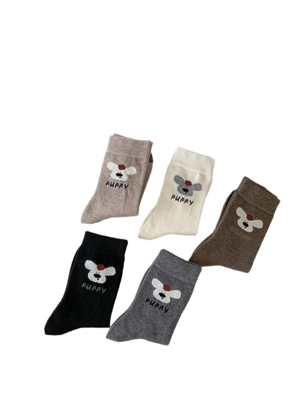 Five puppy motif crew sock colorways arranged on a white background