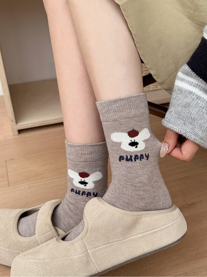 Light coffee puppy motif crew socks worn with beige shoes