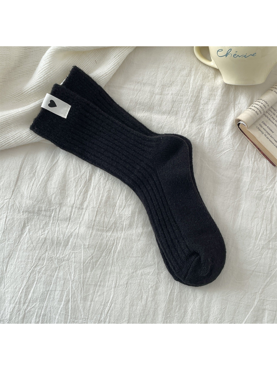 Black ribbed crew socks with a heart label